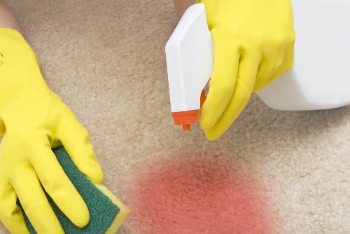 Professional carpet cleaner in Kennington deep cleaning a living room carpet