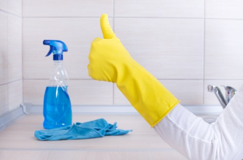 Worker following safe carpet cleaning procedures indoors